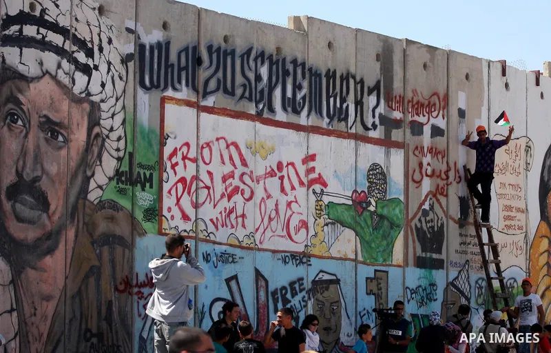 Palestinians take part during a protest calling for a Palestinian state with full UN membership at the Qalandia Israeli checkpoint in the West Bank, near Ramallah, on Sep. 17, 2011. The Palestinians are preparing to subm...