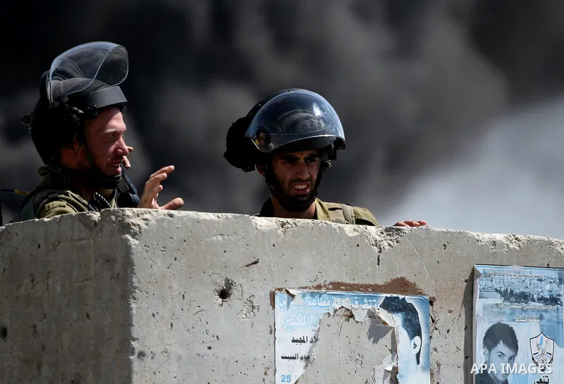 Israeli forces stand behind the Qalandia Israeli checkpoint during a protest calling for a Palestinian state with full UN membership, in the West Bank, near Ramallah, on Sep. 17, 2011. The Palestinians are preparing to s...