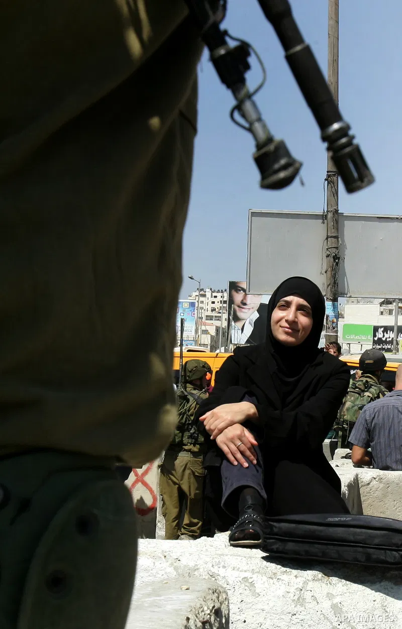 Palestinian women, joined by foreign peace activists and left-wing Israelis, hold up placards calling for a Palestinian state with full UN membership during a protest in Jerusalem, on 17 September 2011. Palestine is set...