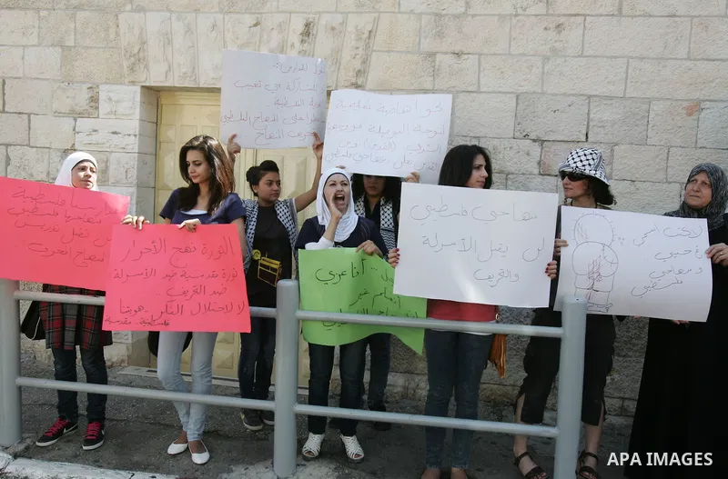 Palestinian women, joined by foreign peace activists and left-wing Israelis, hold up placards calling for a Palestinian state with full UN membership during a protest in Jerusalem, on 17 September 2011. Palestine is set...