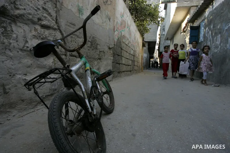 Palestinian children walk outside their house at Rafah refugee camp, southern Gaza Strip on Sep. 17, 2011. The Palestinians are preparing to submit a formal request to become the 194th member of the United Nations when t...
