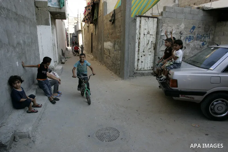 Palestinian children play outside their house at Rafah refugee camp, southern Gaza Strip on Sep. 17, 2011. The Palestinians are preparing to submit a formal request to become the 194th member of the United Nations when t...