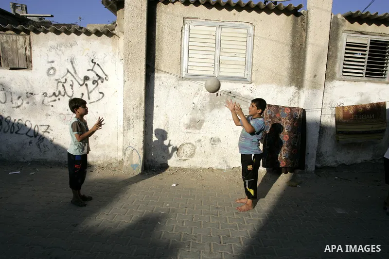Palestinian children play football outside their house at Rafah refugee camp, southern Gaza Strip on Sep. 17, 2011. The Palestinians are preparing to submit a formal request to become the 194th member of the United Natio...