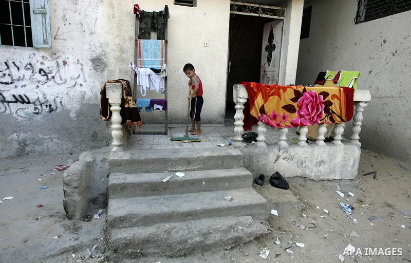 A Palestinian boy cleans his house at Rafah refugee camp, southern Gaza Strip on Sep. 17, 2011. The Palestinians are preparing to submit a formal request to become the 194th member of the United Nations when the General...