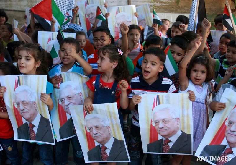 Palestinian children hold posters, in support with the Palestinian President Mahmoud Abbas, during a rally in the village of Azmut in the West Bank city of Nablus, on Sept. 18, 2011. Palestinian President Mahmoud Abbas i...
