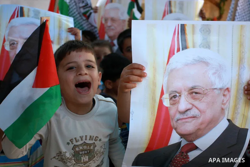 Palestinian children hold posters, in support with the Palestinian President Mahmoud Abbas, during a rally in the village of Azmut in the West Bank city of Nablus, on Sept. 18, 2011. Palestinian President Mahmoud Abbas i...