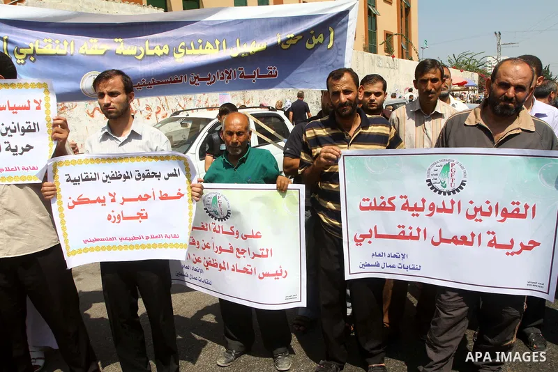 Palestinians take part in a protest in front of the UNRWA headquarters, against reducing the services provided to Palestine refugees in Gaza city, on Sep. 18, 2011. Photo by Ashraf Amra