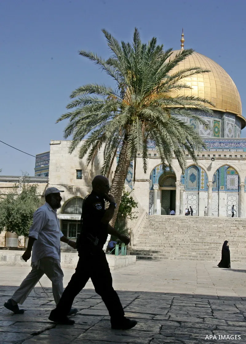 A group of religious Jews walks in front of the Dome of the Rock on a visit to the Al-Aqsa mosques compound under Israeli police protection in Jerusalem's Old City on September 18, 2011. The Dome of the Rock (C), Islam's...