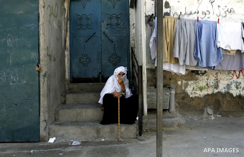 A Palestinian woman sits on a street on September 18, 2011, at refugee camp in the southern Gaza Strip. The Palestinians are preparing to submit a formal request to become the 194th member of the United Nations when the...