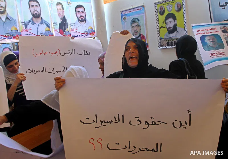 Palestinian women hold pictures of their prisoned relatives in Israeli jails as they gather in a weekly activity calling for their liberty at the Red Cross headquarters in Gaza City on Sep. 19, 2011. About 7000 prisoners...