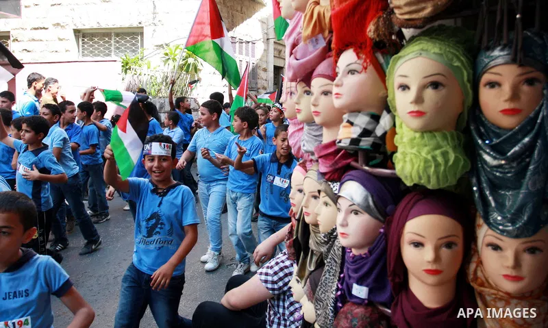 Palestinian schoolchildren hold their national flag during a rally in the West Bank city of Tulkarem, Monday, Sept. 19, 2011. Abbas is set to address the U.N. this week, planning to ask the world to recognize a Palestini...