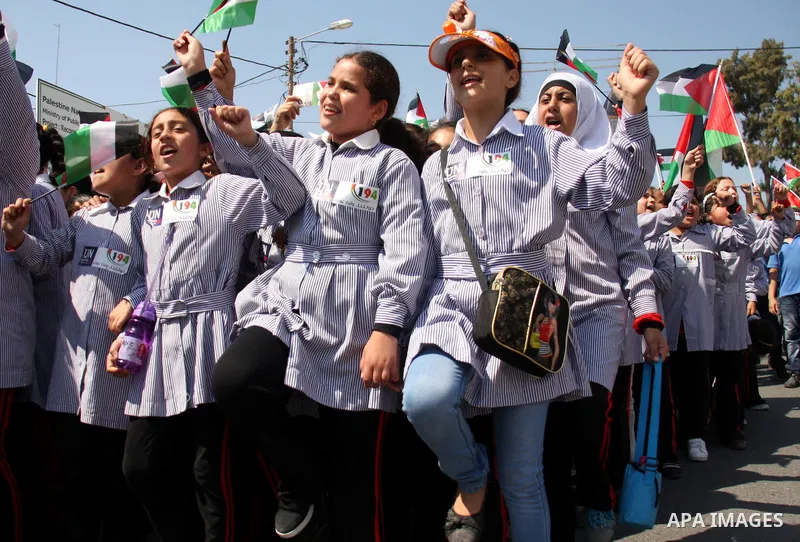 Palestinian schoolchildren hold their national flag during a rally in the West Bank city of Tulkarem, Monday, Sept. 19, 2011. Abbas is set to address the U.N. this week, planning to ask the world to recognize a Palestini...