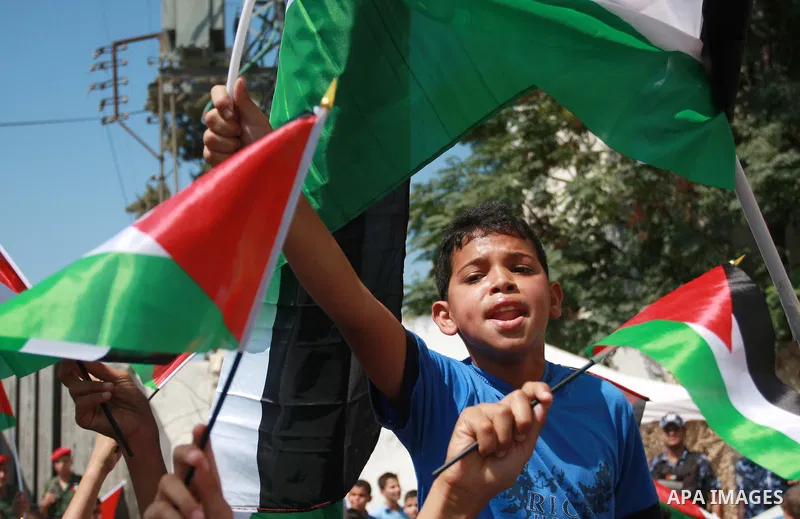 Palestinian schoolchildren hold their national flag during a rally in the West Bank city of Tulkarem, Monday, Sept. 19, 2011. Abbas is set to address the U.N. this week, planning to ask the world to recognize a Palestini...