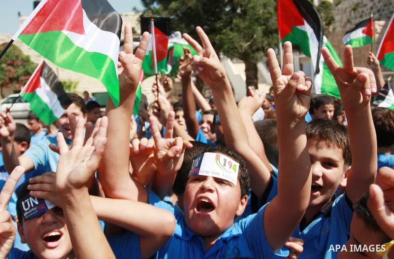 Palestinian schoolchildren hold their national flag during a rally in the West Bank city of Tulkarem, Monday, Sept. 19, 2011. Abbas is set to address the U.N. this week, planning to ask the world to recognize a Palestini...