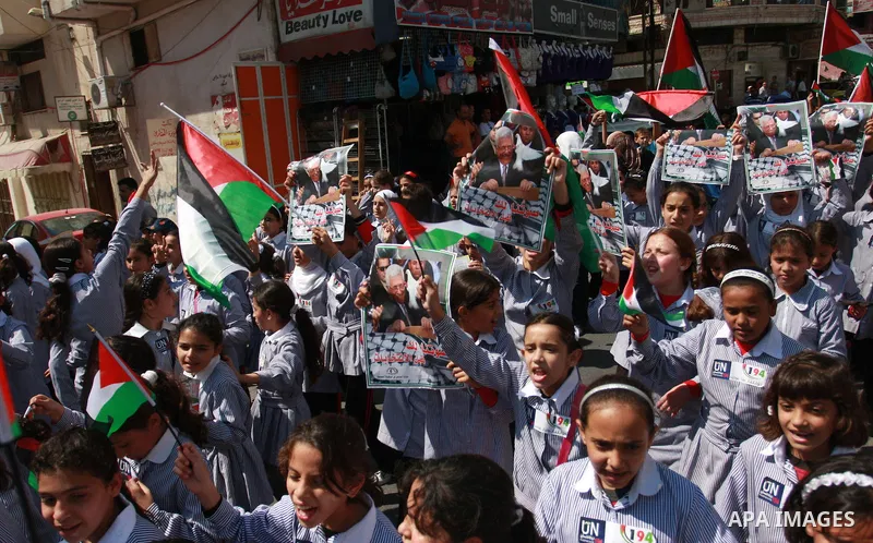 Palestinian schoolchildren hold their national flag during a rally in the West Bank city of Tulkarem, Monday, Sept. 19, 2011. Abbas is set to address the U.N. this week, planning to ask the world to recognize a Palestini...