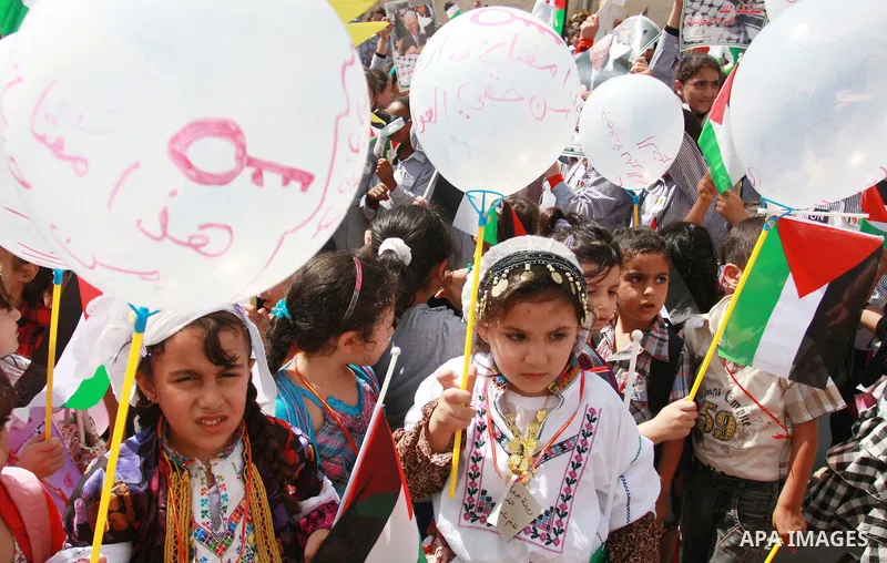 Palestinian schoolchildren hold their national flag during a rally in the West Bank city of Tulkarem, Monday, Sept. 19, 2011. Abbas is set to address the U.N. this week, planning to ask the world to recognize a Palestini...