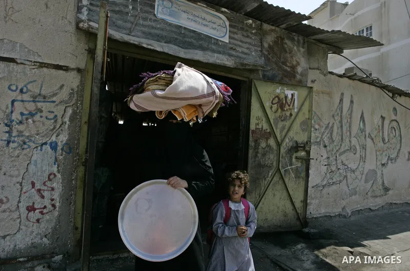 A Palestinian woman bakes bread in a traditional mud oven in Rafah refugee camp, southern Gaza Strip on September 19, 2011. A diplomatic showdown looms at the United Nations this month when Palestinian President Mahmoud...