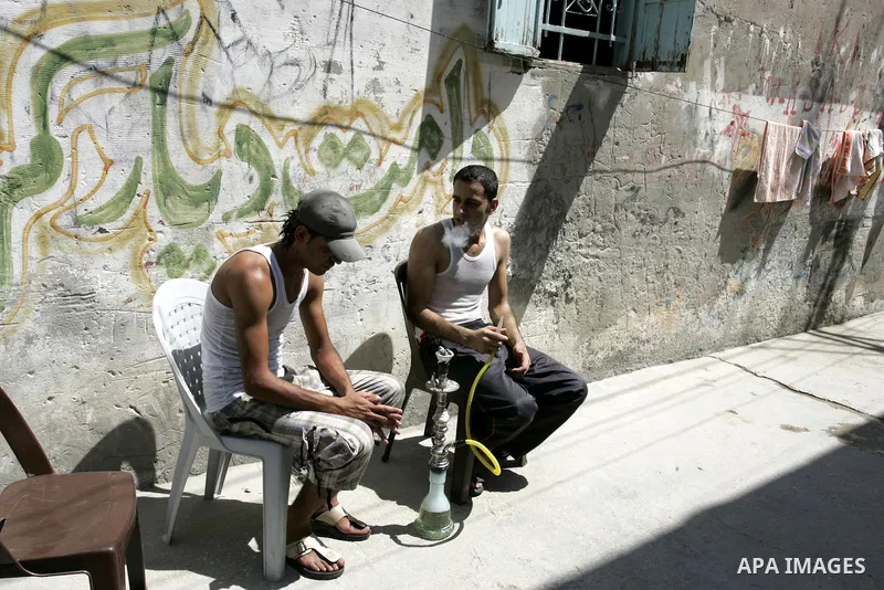 Palestinian youths smoke a water pipe in the Rafah refugee camp, southern Gaza Strip on Sep. 19, 2011. Attend the 66th General Assembly session of United Nations, which begins Tuesday, Sep. 20. The United States and Euro...