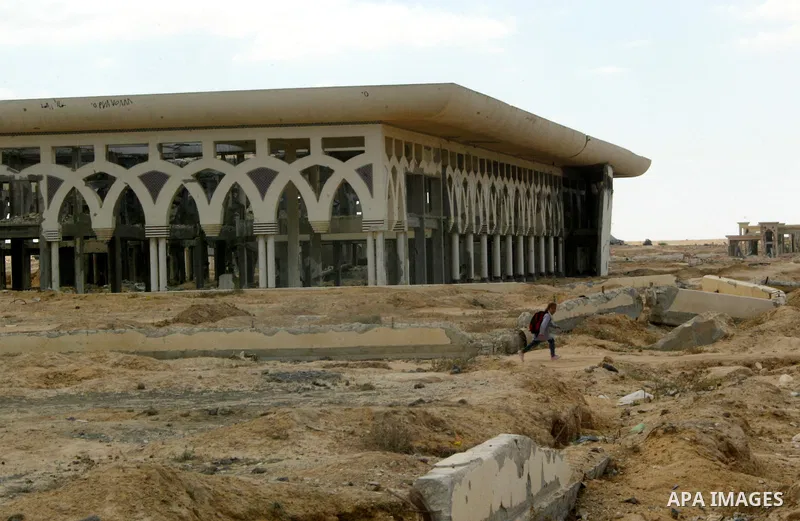 A Palestinian walks the rubble of the Gaza International Airport in Rafah in the southern Gaza Strip, on September 20, 2011. The 70-million-dollar airport which opened in November 1998 has been closed since February 2001...