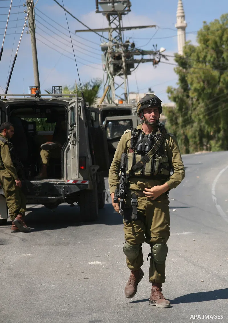 Israeli troops take position in the West Bank village of Beit Omar, near Hebron during clashes with Palestinians on 20 September 2011. President Mahmoud Abbas intends to make a bid on 23 September for United Nations memb...