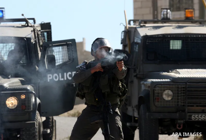 Israeli soldiers fires tear gas canister during clashes with Palestinians in the West Bank village of Assira al-Kibliya, Tuesday, Sept. 20, 2011. Israeli settlers and Palestinian villagers threw stones at each other Tues...