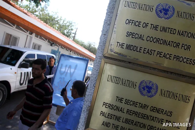Palestinian carpenter Mustafa Masoud, 24, takes a chair symbolizing the Palestinian statehood bid from his house to be placed in front of the UN offices in Gaza city, Wednesday, Sept. 21, 2011. Writing in Arabic reads "P...