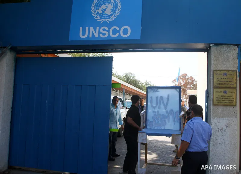 Palestinian carpenter Mustafa Masoud, 24, takes a chair symbolizing the Palestinian statehood bid from his house to be placed in front of the UN offices in Gaza city, Wednesday, Sept. 21, 2011. Writing in Arabic reads "P...