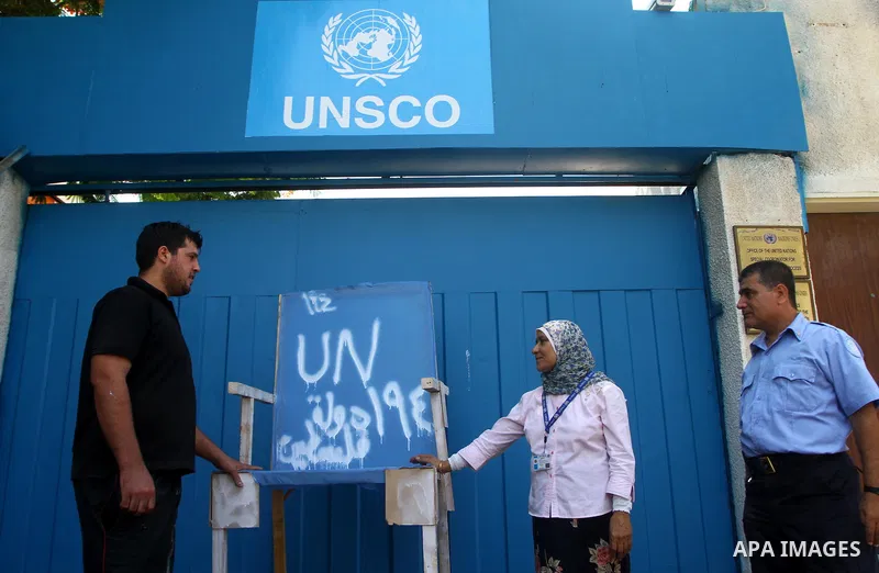 Palestinian carpenter Mustafa Masoud, 24, takes a chair symbolizing the Palestinian statehood bid from his house to be placed in front of the UN offices in Gaza city, Wednesday, Sept. 21, 2011. Writing in Arabic reads "P...