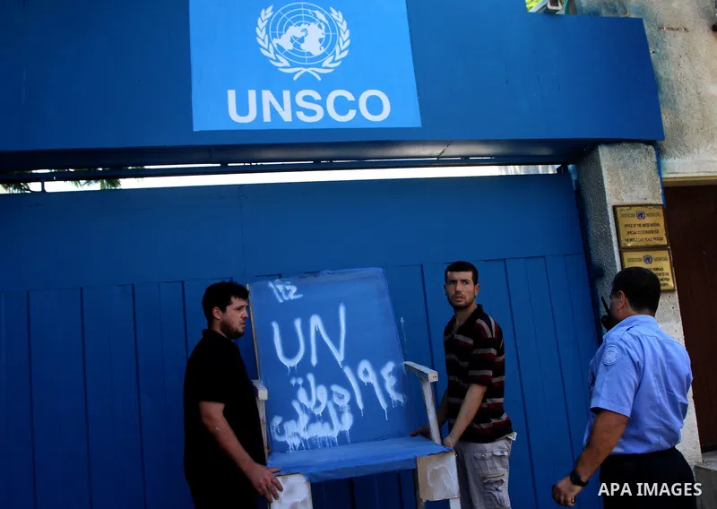 Palestinian carpenter Mustafa Masoud, 24, takes a chair symbolizing the Palestinian statehood bid from his house to be placed in front of the UN offices in Gaza city, Wednesday, Sept. 21, 2011. Writing in Arabic reads "P...