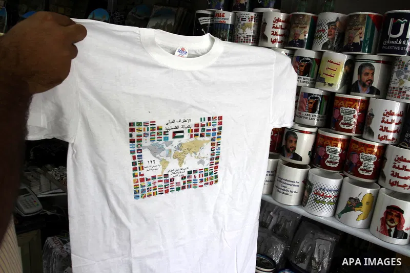A Palestinian vendor displays the palestinian flag on a shirts, in support of Palestinian President Mahmoud Abbas' bid for statehood recognition in the United Nations on September 21, 2011. Abbas plans on Friday to submi...