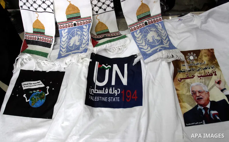 A Palestinian vendor displays the United Nation logo on a shirts, in support of Palestinian President Mahmoud Abbas' bid for statehood recognition in the United Nations on September 21, 2011. Abbas plans on Friday to sub...