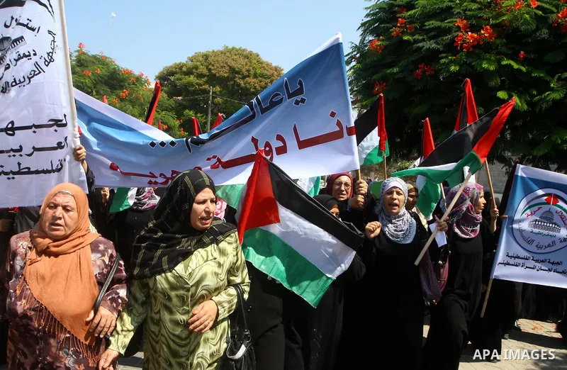 A Palestinian women chant slogans during a demonstration in support of Palestinian leader Mahmud Abbas' bid for statehood recognition at the United Nations on September 21, 2011 in Gaza City. Palestinians are preparing t...