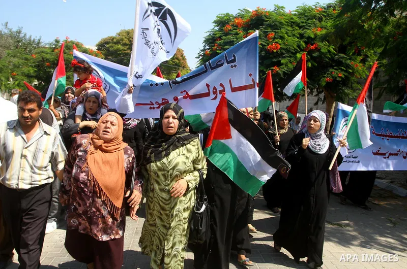 A Palestinian women chant slogans during a demonstration in support of Palestinian leader Mahmud Abbas' bid for statehood recognition at the United Nations on September 21, 2011 in Gaza City. Palestinians are preparing t...