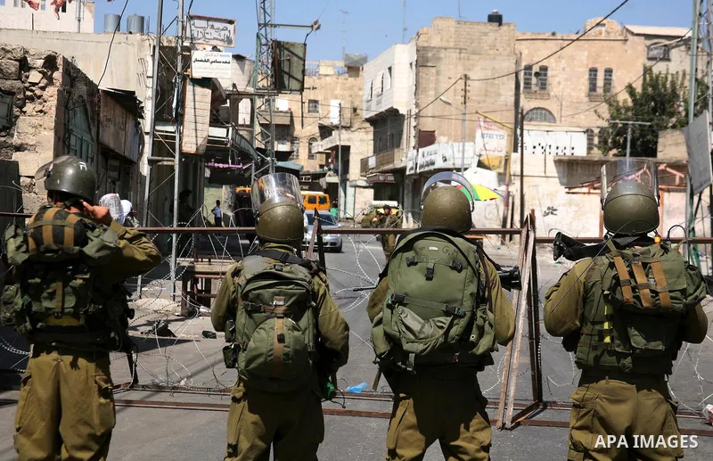Israeli soldiers take position during clashes with Palestinians following a protest in the West Bank city of Hebron 21 September 2011, as Palestinian president Mahmud Abbas prepares to submit a formal request for Palesti...