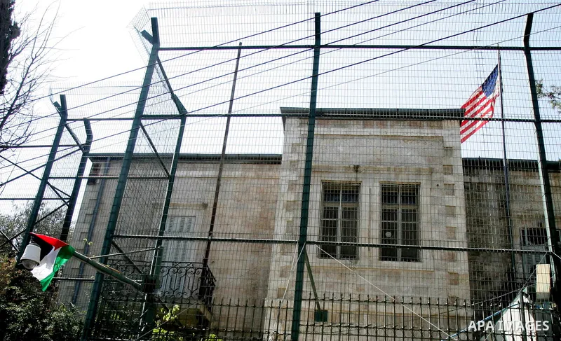 A Palestinian flag hangs on the fence of the US General Consulate in east Jerusalem during a protest against US' interference in the Palestinian bid for statehood recognition at the United Nations on September 21, 2011....