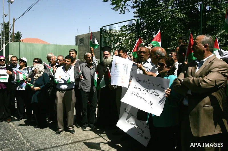Palestinians protest against US' interference in the Palestinian bid for statehood recognition at the United Nations on September 21, 2011 outside the US General Consulate in east Jerusalem. Palestinians are preparing to...