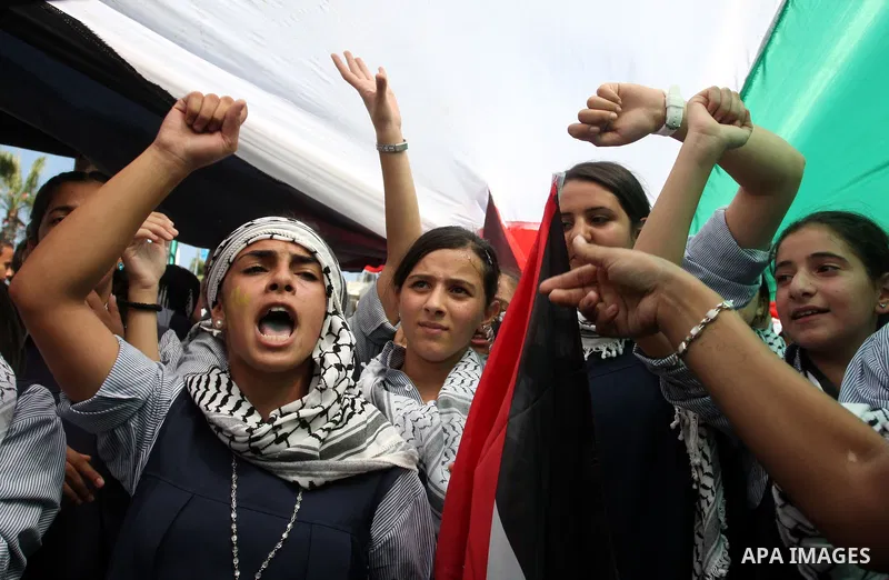 Palestinians participate in a rally in support of the Palestinian bid for statehood recognition in the United Nations, in the West Bank city of Ramallah, Wednesday, Sept. 21, 2011. Thousands of flag-waving Palestinians r...