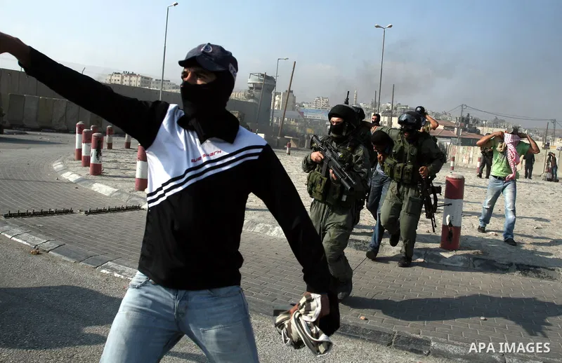Undercover Israeli police and border police officers arrest Palestinian demonstrators during clashes with the Israeli military at the Qalandia checkpoint between the West Bank city of Ramallah and Jerusalem, Wednesday, S...