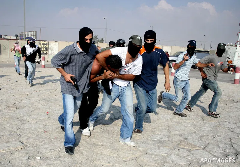 Undercover Israeli police and border police officers arrest Palestinian demonstrators during clashes with the Israeli military at the Qalandia checkpoint between the West Bank city of Ramallah and Jerusalem, Wednesday, S...