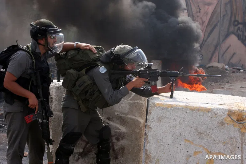 Israeli soldiers take position during clashes with Palestinian protesters at the Qalandia checkpoint between the West Bank city of Ramallah and Jerusalem, Wednesday, Sept. 21, 2011. Palestinians clashed with Israeli secu...