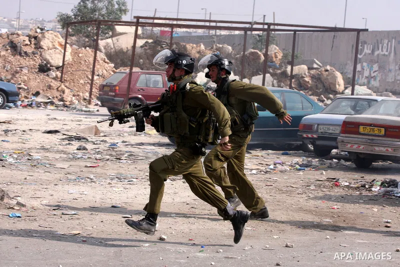 Israeli soldiers run to take position during clashes with Palestinian protesters at the Qalandia checkpoint between the West Bank city of Ramallah and Jerusalem, Wednesday, Sept. 21, 2011. Palestinians clashed with Israe...