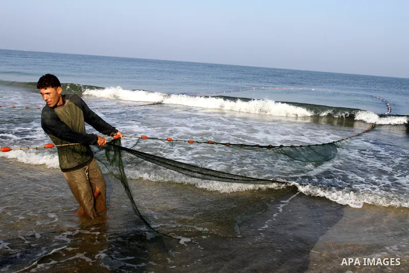 Palestinian fishermen pull their nets at the beach of Gaza city on Sep. 22, 2011. Palestinians hoped that the blockade is lifted from the sea, and setting "Palestine state 194", representing their hope to become the 194t...