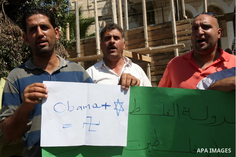 Palestinians hold up signs against US President Barack Obama during a protest in the northern West Bank city of Nablus on September 22, 2011. Palestinians slammed US President Barack Obama's United Nations address a day...