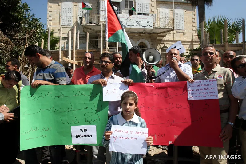 Palestinians hold up signs against US President Barack Obama during a protest in the northern West Bank city of Nablus on September 22, 2011. Palestinians slammed US President Barack Obama's United Nations address a day...