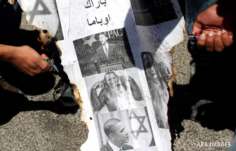 Palestinians burn manipulated pictures of US President Barack Obama during an anti U.S. demonstration in the West Bank city of Ramallah, Thursday, Sept. 22, 2011. Palestinian protesters have denounced President Barack Ob...