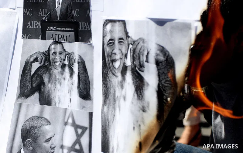 Palestinians burn manipulated pictures of US President Barack Obama during an anti U.S. demonstration in the West Bank city of Ramallah, Thursday, Sept. 22, 2011. Palestinian protesters have denounced President Barack Ob...