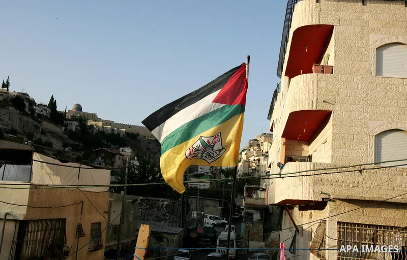 A Palestinian flag hangs on a house, Al-Aqsa mosque in the background, on September 22, 2011 in the east Jerusalem neighborhood of Silwan. Palestinians are preparing to submit a formal request to become the 194th member...