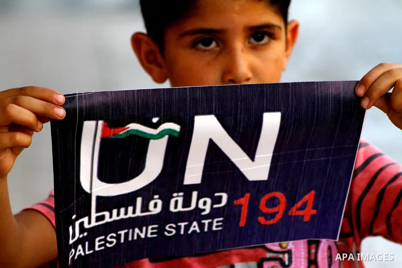 A Palestinian boy rides a bicycle decorated with a sign supporting the Palestinians' bid in the United Nations for statehood recognition, on September 23, 2011 in Gaza City. Palestinian president Mahmud Abbas will presen...