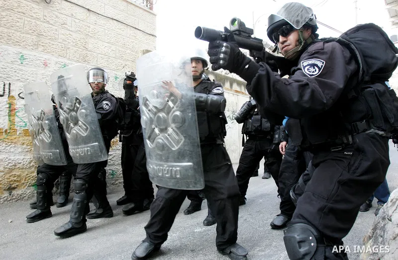 Israeli border guards advance behind shields during clashes with Palestinian stone throwers in the east Jerusalem neighborhood of Ras al-Amud on September 23, 2011, just hours before the president, Mahmoud Abbas, was to...