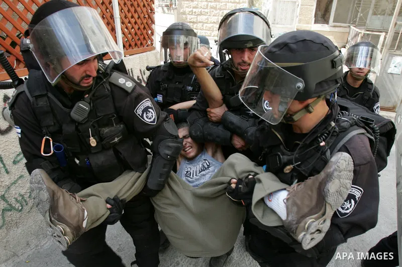 Israeli border police arrest a Palestinian youth for throwing stones at their checkpoint in Ras al-Amud neighborhood of East Jerusalem, Friday Sept. 23, 2011, just hours before their president, Mahmoud Abbas, was to deli...